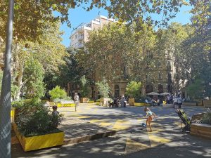 Sogenannte Superilla in de Sant Antoni in Barcelona, Platz mit Gründerzeitbebauung, Bäumen und spielenden Kindern.